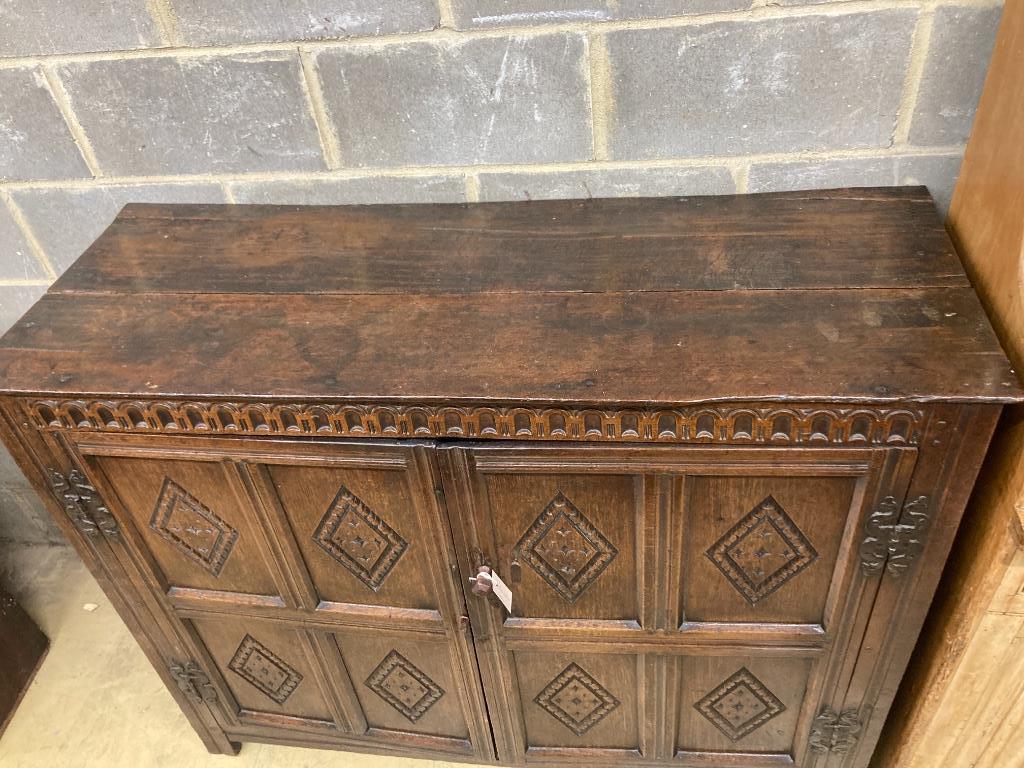 A 17th century carved and panelled oak cupboard